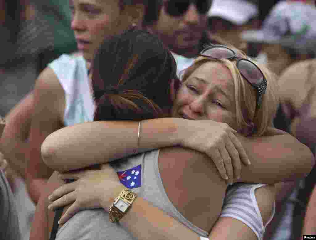 Relatives of victims of the 2002 Bali bomb attack comfort each other during a commemoration service for the 10th anniversary of the Bali bombing in Garuda Wisnu Kencana (GWK) cultural park in Jimbaran, Bali October 12, 2012.