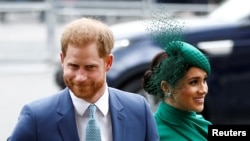 FILE - Britain's Prince Harry and Meghan, Duchess of Sussex, arrive for the annual Commonwealth Service at Westminster Abbey in London, March 9, 2020.