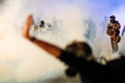 Federal officers use chemical irritants and projectiles to disperse protesters at the Mark O. Hatfield United States Courthouse in Portland, Oregon, July 24, 2020.