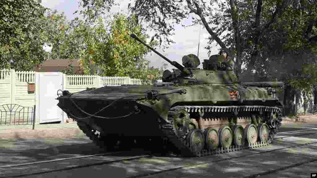 An armored personal carrier travels through the town of Donetsk, eastern Ukraine, Oct. 1, 2014.