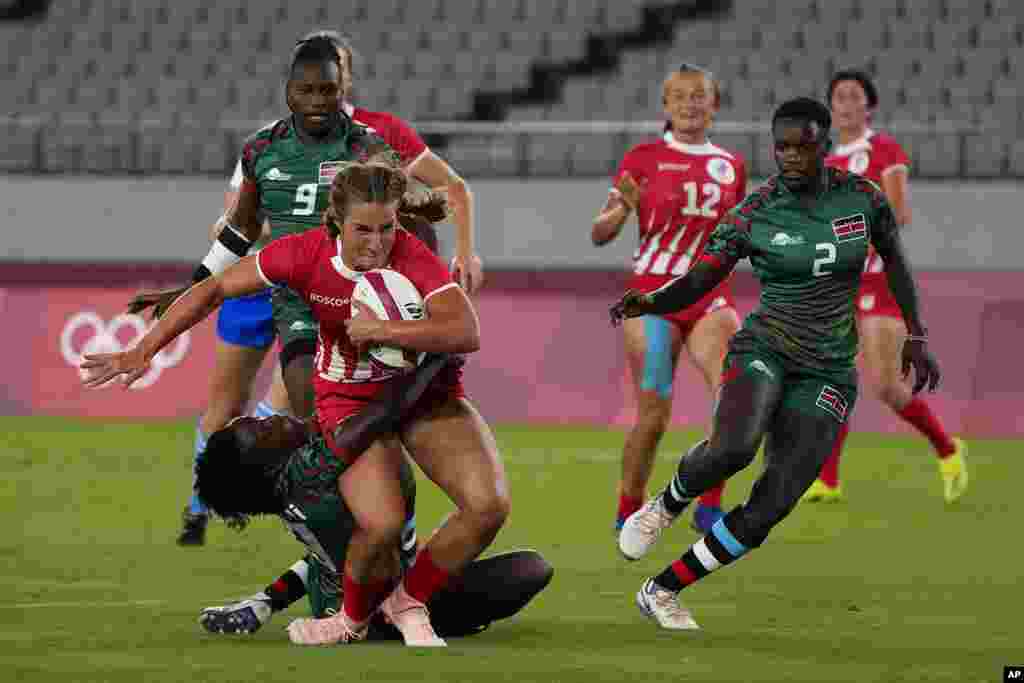 Russian Olympic Committee's Kristina Seredina, left, is tackled by Kenya's Sinaida Omondi, as she runs on her way to scoring a try in their women's rugby sevens match at the 2020 Summer Olympics, Thursday, July 29, 2021 in Tokyo, Japan. (AP Photo/Shuji Kajiyama)