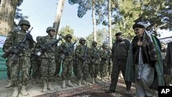 Ashraf Ghani Ahmadzai (R), head of the Transition Commission, inspects an Afghan military guard during a ceremony to hand over security control in Qala Naw, center of Badghis province, File January 31, 2012.