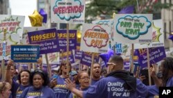 FILE - Members of 1199 Service Employees FILE - International Union march up Fifth Avenue in the annual Labor Day Parade in New York in 2015. (AP Photo/Bryan R. Smith)