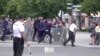 Potongan gambar dari sebuah video yang menunjukkan anggota pasukan pengamanan Perdana Menteri Slovakia Robert Fico menahan seorang pria dalam insiden penembakan terhadap Fico di Handlova, Slovakia, pada 15 Mei 2024. (Foto: RTV PRIEVIDZA/Handout via Reuters)