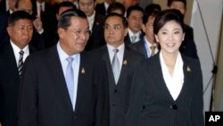 Cambodia's Prime Minister Hun Sen, left, walks with his Thai counterpart Yingluck Shinawatra as they attend ASEAN-UN Summit in Nusa Dua, Bali, Indonesia, file photo.