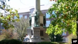 A student reads a book on campus, at Ohio University.