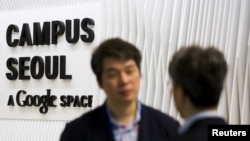 People talk at the entrance to the Google Campus start-up space in the Gangnam district of Seoul. 
