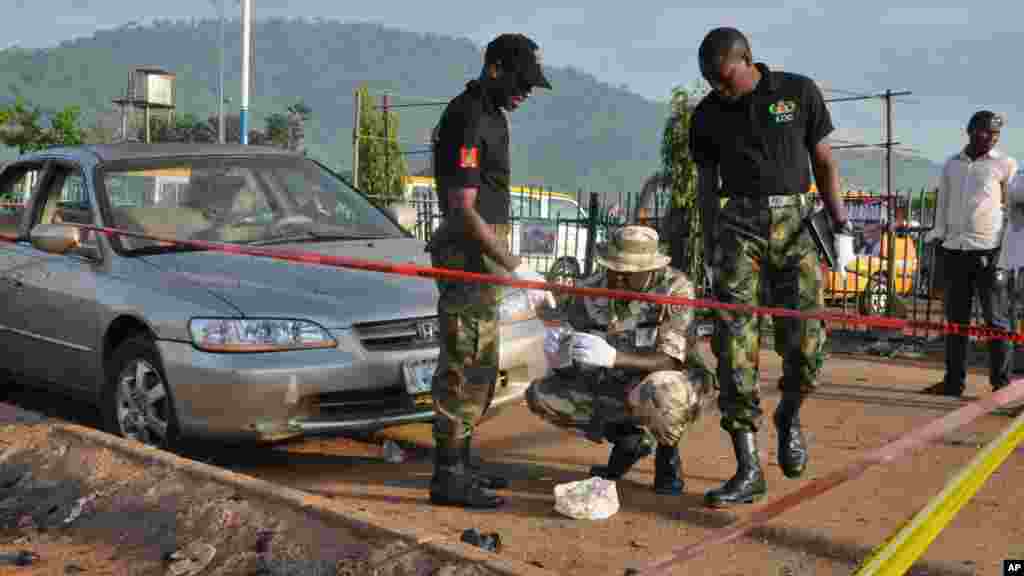 ‘Yan sanda na tattara tarkace a wajenda bom ya tashi, a garin Nyanya dake Abuja.