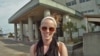 Kate O'Berg in front of one of the schools in Japan where she now teaches.(T.Banse/VOA)