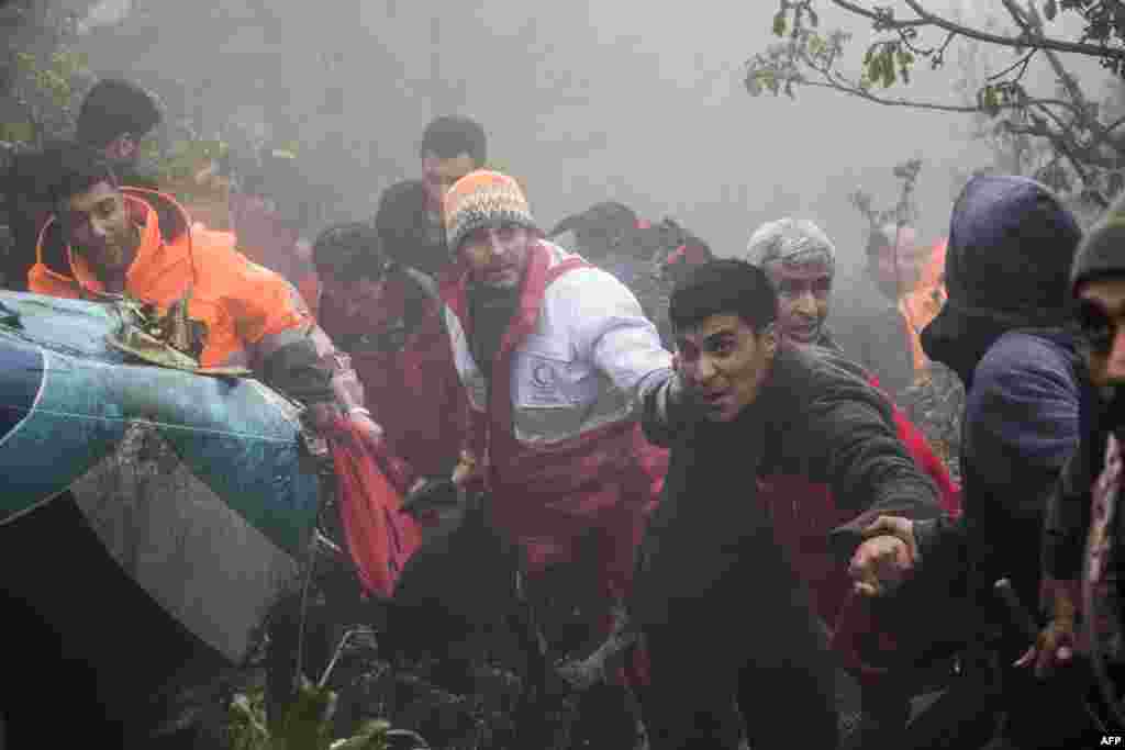 Rescuers recover bodies at the crash site of a helicopter transporting Iran's President, his Foreign Minister, and others in a fog-covered mountainous area of Varzaghan in northwestern Iran, May 20, 2024.
