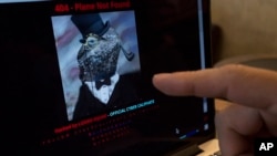 A man points at the computer screen showing Malaysia Airlines' hacked website, at a cafe in Petaling Jaya outside Kuala Lumpur, Malaysia, Monday, Jan. 26, 2015. 
