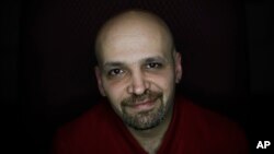 Mahmoud Hassino a homosexual Syrian refugee and gay activist with the Schwulenberatung activist group, poses for the photographer after a news conference in Berlin, Germany, Feb. 22, 2016.