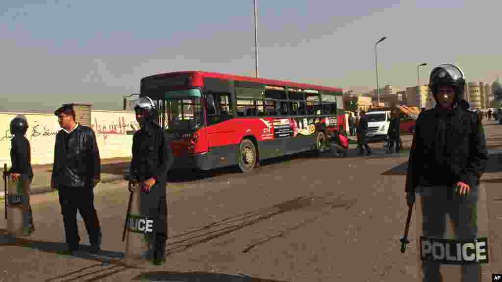 Egyptian police stand guard after an explosion hit a public bus in Cairo's eastern Nasr City district, Dec. 26, 2013.