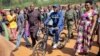 President Pierre Nkurunziza arrives riding a bicycle, accompanied by First Lady Denise Bucumi Nkurunziza, right, to cast his vote for the presidential election, in Ngozi, Burundi Tuesday, July 21, 2015. 