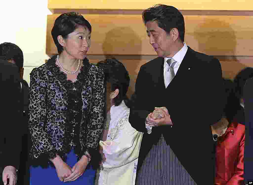 Japan's Prime Minister Shinzo Abe and his newly appointed Trade Minister Yuko Obuchi chat prior to a group photo following the first cabinet meeting at the prime minister's official residence, in Tokyo, Sept. 3, 2014.