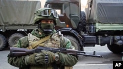 FILE - A pro-Russia rebel stands guard in Donetsk, eastern Ukraine, Oct. 29, 2015.