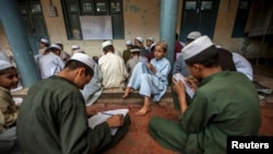 FILE - Pakistani religious students attend a lesson at Darul Uloom Haqqania, an Islamic seminary in Akora Khattak, Khyber Pakhtunkhwa province, Sept. 14, 2013.