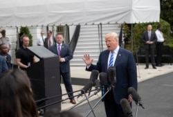 FILE - President Donald Trump talks to the media at the White House as he leaves for Dallas to address the National Rifle Association, May 4, 2018.