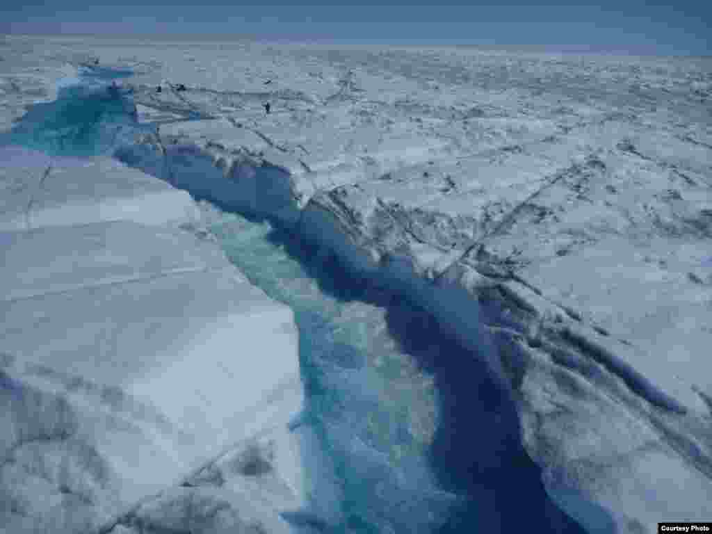 Greenland’s supraglacial rivers are large and swift. Note researchers on right for scale! (UCLA/Laurence C. Smith)