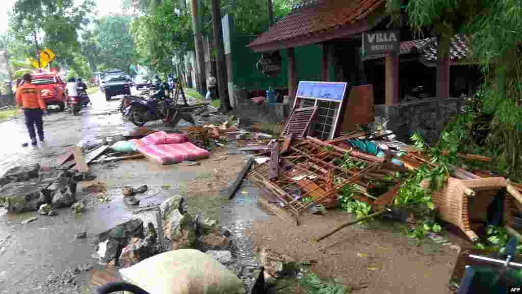 Debris from damaged buildings is seen on a street on Carita beach, Dec. 23, 2018, after the area was hit by a tsunami, Saturday that was triggered by an eruption of the Anak Krakatoa volcano.