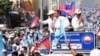 FILE - Opposition party Cambodia National Rescue Party officials greet their supporters from a truck as they lead a rally during the last day of campaigning ahead of communal elections in Phnom Penh, Cambodia, Friday, June 2, 2017. (AP Photo/Heng Sinith)