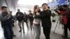 A relative of a passenger onboard Malaysia Airlines flight MH370 cries as she talks on her mobile phone at the Beijing Capital International Airport in Beijing, China, March 8, 2014. 