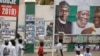 Un panneau d'affichage montrant le président du Nigeria Muhammadu Buhari et d'autres responsables du parti APC, à Kano, dans le nord du Nigeria, le 26 février 2019.