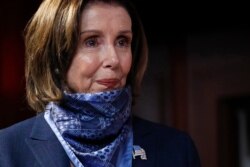 FILE - House Speaker Nancy Pelosi, D-Calif., waits to speak with reporters after the Senate approved a nearly $500 billion coronavirus aid bill, April 21, 2020, on Capitol Hill in Washington.