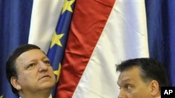 President of the European Commission Jose Manuel Barroso, left, listens to Hungarian Prime Minister Viktor Orban, right, during a meeting between the college of EU commissioners and the Hungarian government at the parliament building in Budapest, Friday,