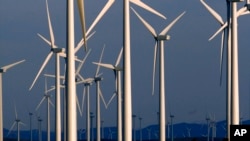 FILE - A wind turbine farm. The decision Monday could give another decade of life to California's expiring cap-and-trade program.