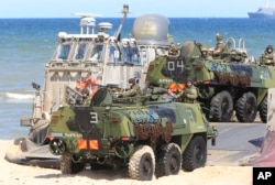 Soldiers sit atop of amphibious vehicles as NATO troops participate in the NATO sea exercises BALTOPS 2015 that are to reassure the Baltic Sea region allies in the face of a resurgent Russia, in Ustka, Poland, June 17, 2015.