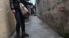 FILE - This photo, taken March 15, 2017, shows a mother pointing to the place where her eight-year-old daughter was molested by a family friend in a residential quarter of Hanoi, Vietnam. Vietnam’s legislation dealing with sexual crimes and human trafficking for years made explicit reference to female victims only; boys were added only recently.