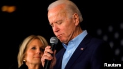 FILE - Democratic presidential candidate and former Vice President Joe Biden is accompanied by his wife Dr. Jill Biden as he addresses supporters at a rally at the Drake University Olmsted Center in Des Moines, Iowa, Feb. 3, 2020.