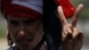 A member of the Muslim Brotherhood and supporters of ousted Egyptian President Mohamed Morsi flashes a victory sign at the Rabaa Adawiya Square, where they are camping, in Nasr city area, east of Cairo, July 28, 2013.