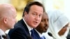 Britain's Prime Minister David Cameron speaks as Britain's Foreign Secretary William Hague, left, and Somali President Hassan Sheikh Mohamud listen at the Somalia conference in London, May 7, 2013.