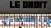 Prisoners are seen at the Makala prison in Kinshasa from behind the bars of the windows of a court room, on December 18, 2012.