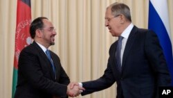 FILE - Russian Foreign Minister Sergey Lavrov, right, and his Afghan counterpart Salahuddin Rabbani shake hands after their meeting in Moscow, Russia, Feb. 7, 2017.