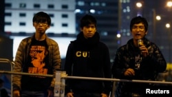 Student leaders Joshua Wong (L-R), Lester Shum and Alex Chow attend a rally at the Occupy Central protest site outside the Legislative Council at Admiralty in Hong Kong, Dec. 10, 2014.