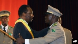 Mali's Interim President Dioncounda Traore (L) is congratulated by coup leader Amadou Sanogo after being sworn in at a ceremony in Bamako, Mali, April 12, 2012. 
