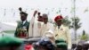 Nigeria's new President Muhammadu Buhari rides on the motorcade while inspecting the guard of honor at Eagle Square in Abuja, Nigeria, May 29, 2015. 