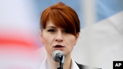 FILE - Maria Butina, leader of a pro-gun organization in Russia, speaks to a crowd during a rally in support of legalizing the possession of handguns in Moscow, Russia, April 21, 2013.