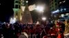 Members of a band wearing Santa Claus costumes perform during the illumination of a giant Christmas tree at the launch of Christmas festivities at Sassine square in the Achrafieh district of Beirut, Lebanon, Dec. 7, 2021. 