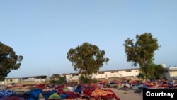 Sisa bangunan pusat penahanan tampak rapuh setelah pemboman dan lima hari kemudian, para migran tidur di luar, tampak dalam foto yang dikirim ke VOA, 7 Juli 2019 di Tripoli, Libya.
