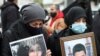 Supporters of victims of the Beirut port explosion react during a protest, after a Lebanese court removed the judge leading the investigation into the explosion, outside the Justice Palace in Beirut, Lebanon, Feb. 19, 2021. 