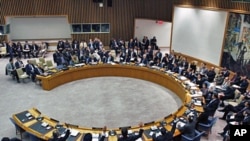 United Nations Security Council diplomats vote on a resolution during a meeting on Libya at UN headquarters in New York, February 26, 2011