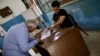 Retired pharmacist Makhmoud Mokhtar, left, cast his vote for Ahmed Shafiq, Cairo, Egypt, June 16, 2012. (Y. Weeks/VOA)