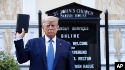 President Donald Trump holds a Bible as he visits outside St. John's Church across Lafayette Park from the White House Monday, June 1, 2020, in Washington. Park of the church was set on fire during protests on Sunday night. (AP Photo/Patrick…