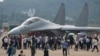 Visitors look at the Chinese military's J-16D electronic warfare airplane during 13th China International Aviation and Aerospace Exhibition, also known as Airshow China 2021, on Wednesday, Sept. 29, 2021, in Zhuhai in southern China's Guangdong province. 