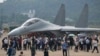 FILE - Visitors look at the Chinese military's J-16D electronic warfare airplane during an air show, Sept. 29, 2021, in Zhuhai, China. Some observers are warning that the U.S. faces an uncertain future in which China and other nations could challenge its technological dominance.
