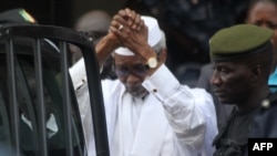 Former Chadian dictator Hissene Habre is escorted by military officers after being heard by a judge on Jul. 2, 2013 in Dakar, Senegal.